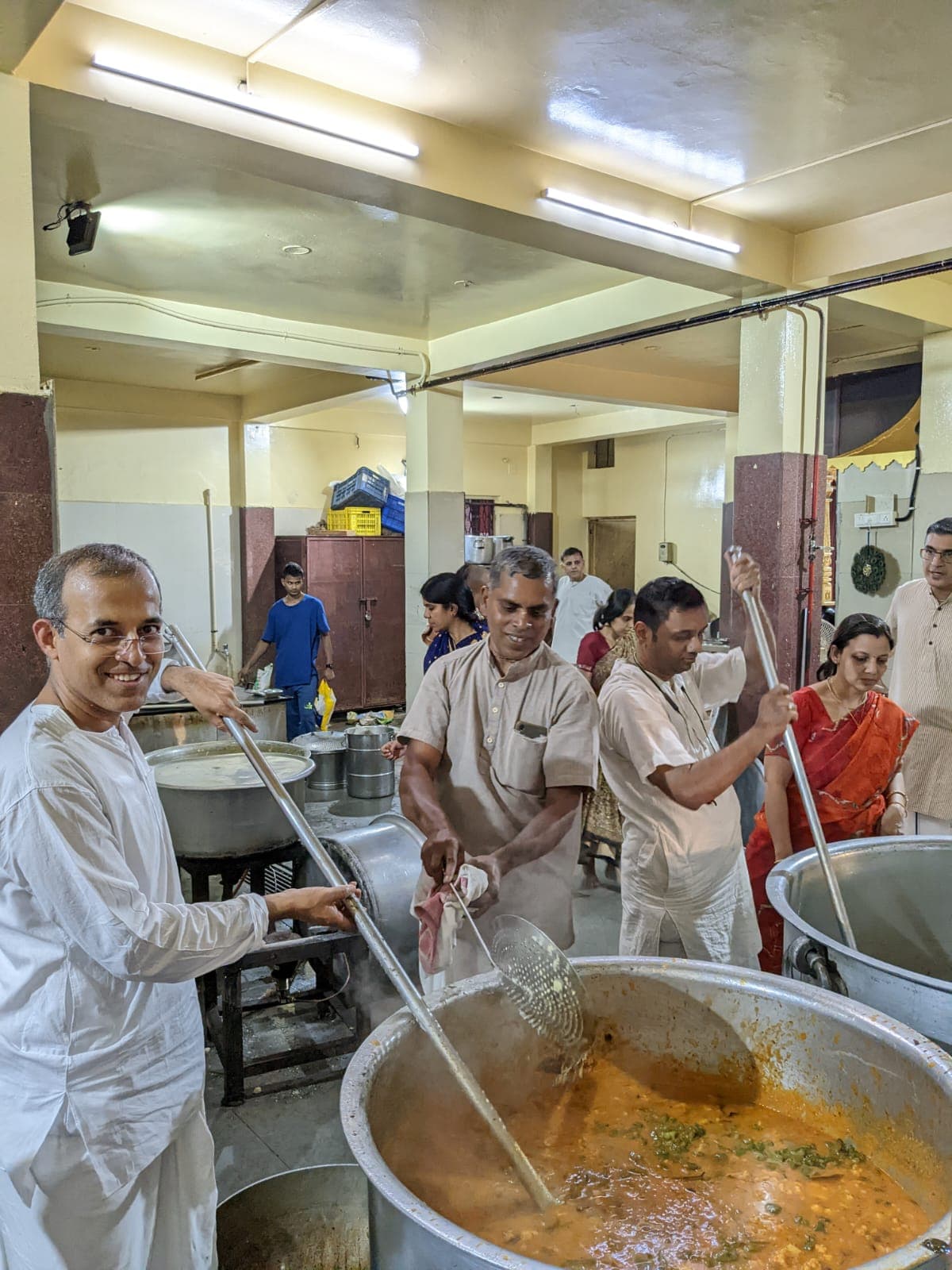 Devotees preparing prasadam in the temple kitchen